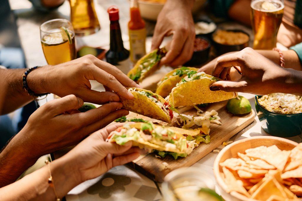 Close up of people eating Mexican food in a restaurant.