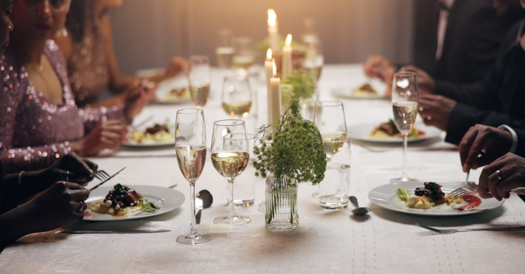 Hands, dinner and business people at party with food, drinks or plate for charity drive at night. G.