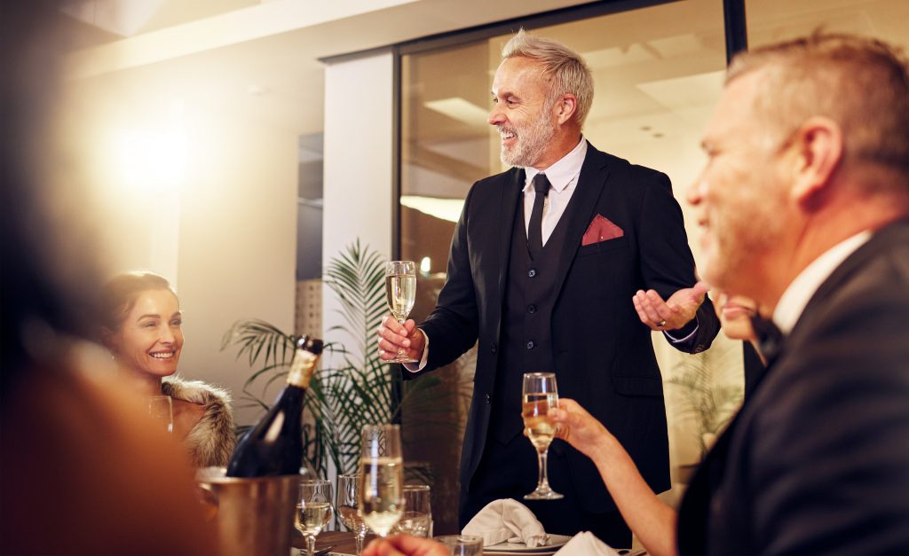 Man, restaurant party and night for toast with friends, business executive team and happy for succe.