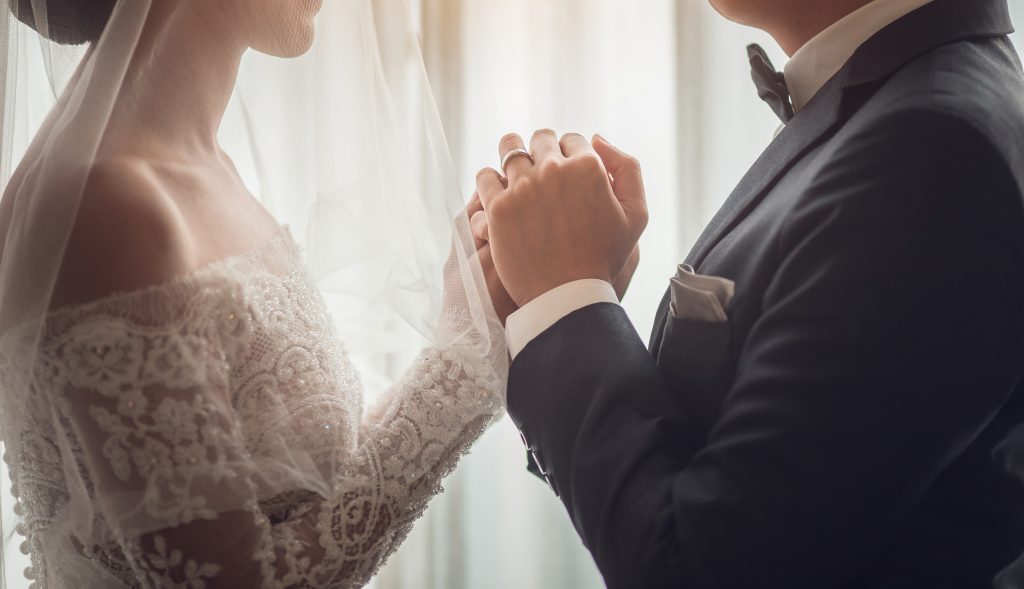 Holding Hands with wedding rings