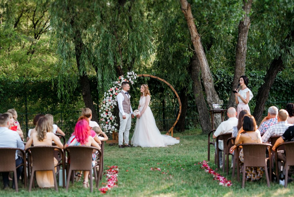 wedding ceremony of a young couple in love on a green meadow in the forest