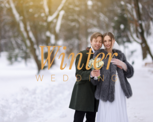 Winter wedding – bride in faux fur wrap and groom in green coat embracing in a snowy forest