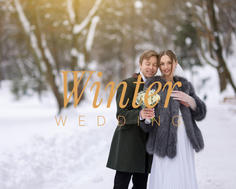 Winter wedding – bride in faux fur wrap and groom in green coat embracing in a snowy forest