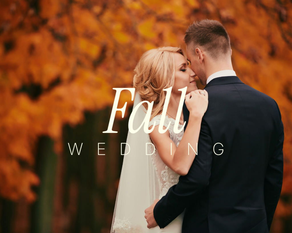 Fall wedding – bride and groom holding hands on a deck surrounded by autumn foliage