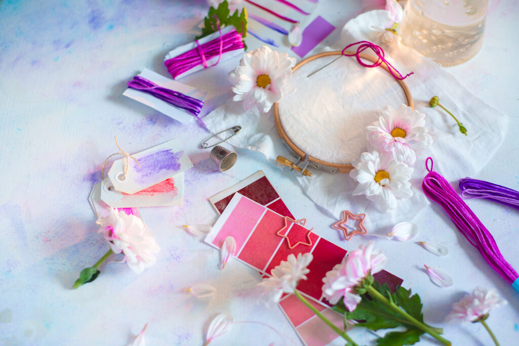 Embroidery frame header with flowers. Pink, white and purple pastel tones, copy space
