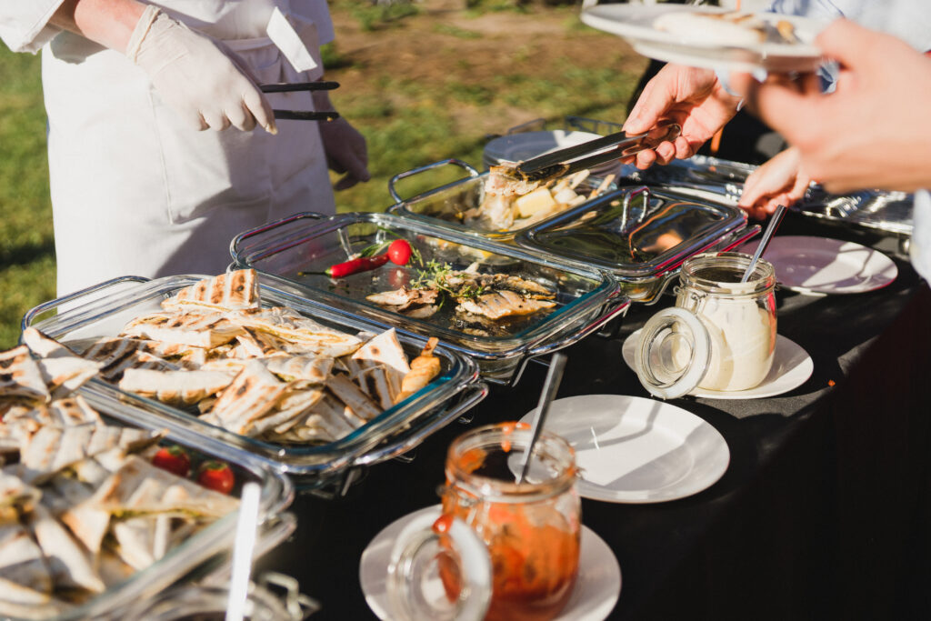 Catering banquet table at reception. Restaurant presentation, european cuisine, food consumption, party concept. Food styling, appetizers bar, welcome drink, event design.