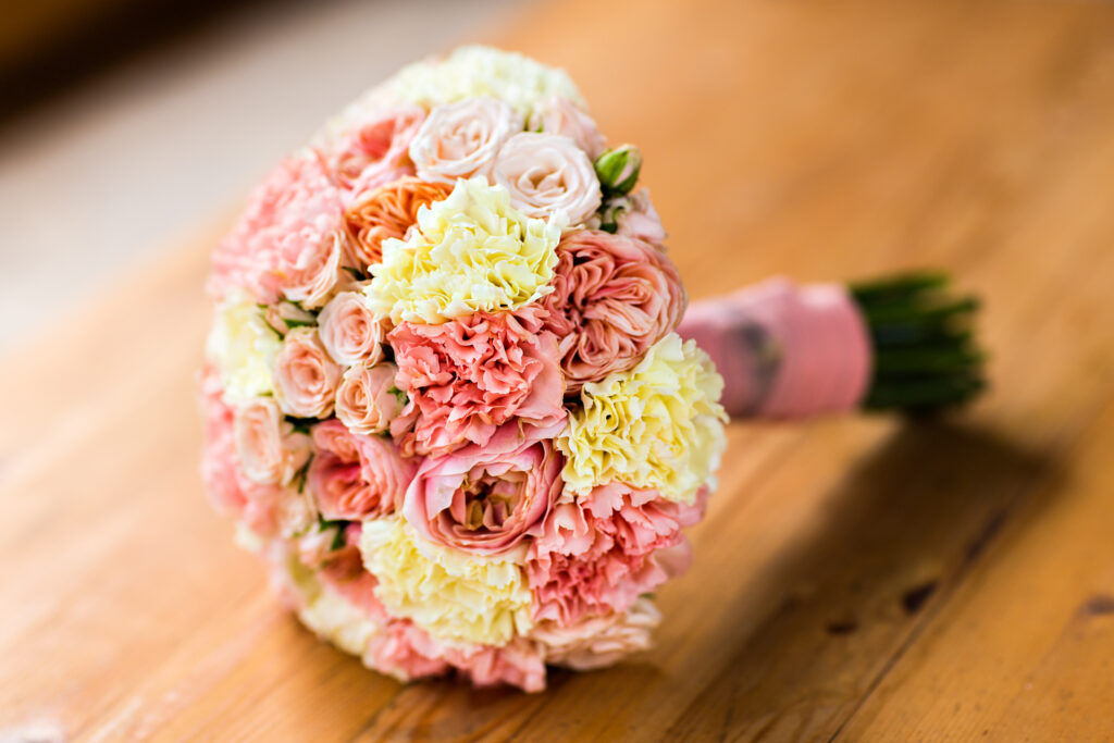 Bride Holding Wedding Bouquet with beautiful Flowers