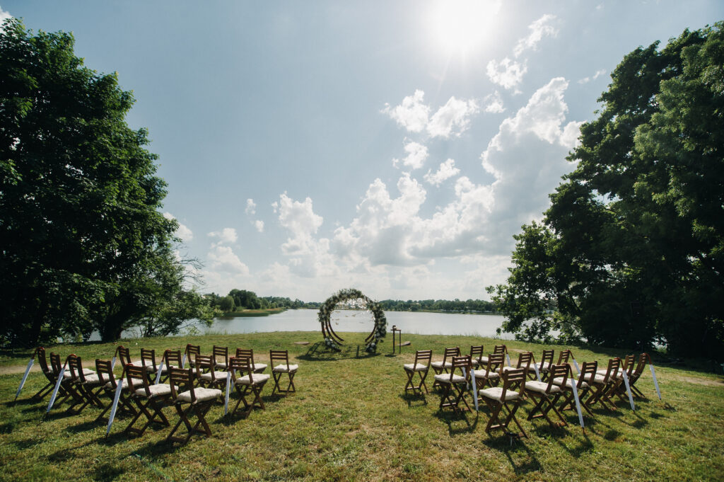 Wedding ceremony on the street on the green lawn.Decor with fresh flowers arches for the ceremony.