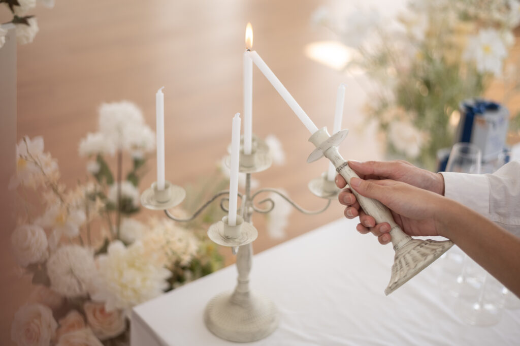 Bride and groom holding wedding candle